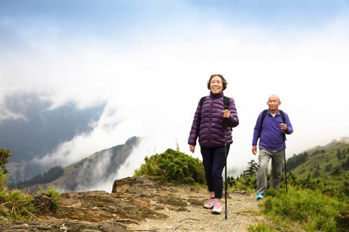 older couple hiking in mountains