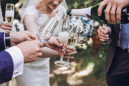 people sharing champagne at wedding
