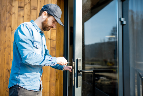 Repairman working on door lock