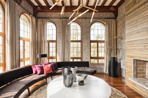 living room with high floor-to-ceiling windows and curvy couch