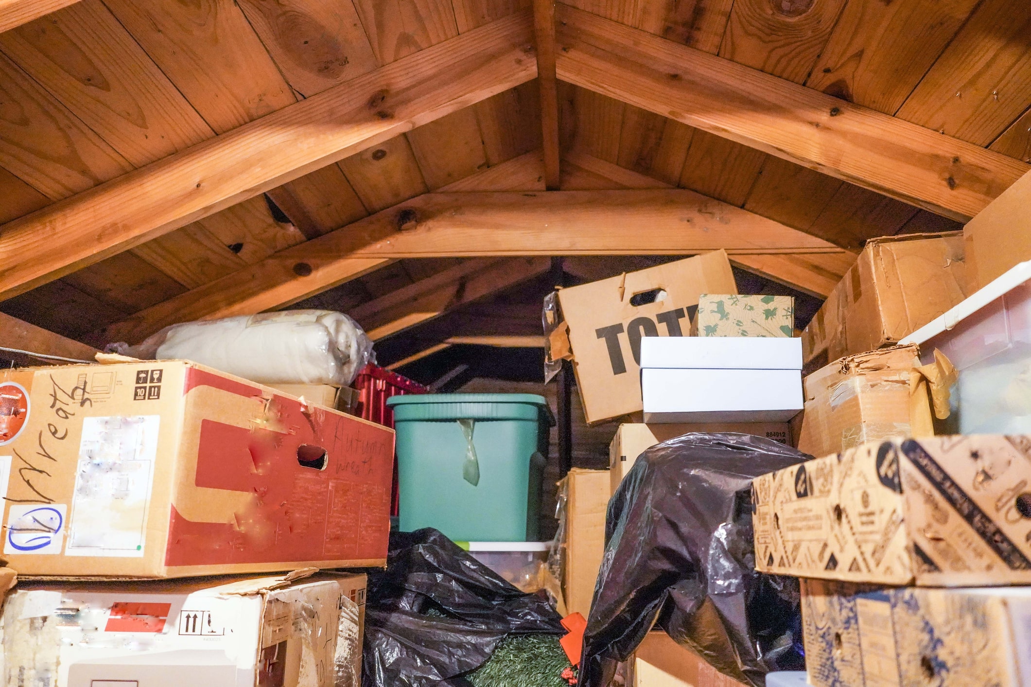 stack of boxes and clutter in home attic