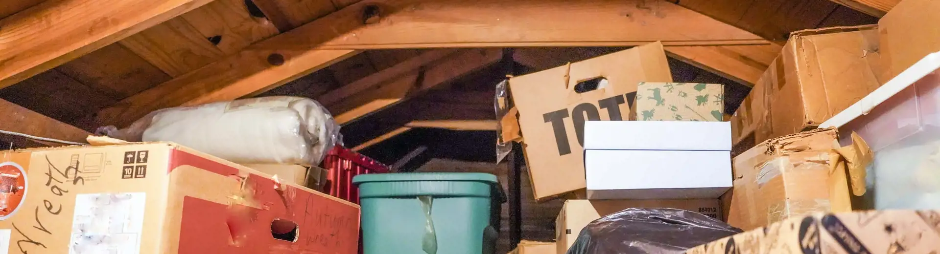 stack of boxes and clutter in home attic