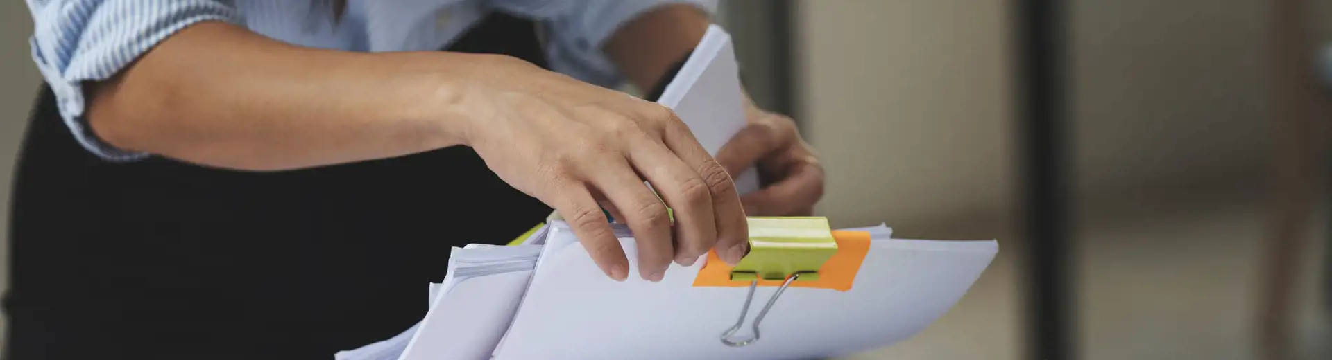 woman organizing stacks of papers