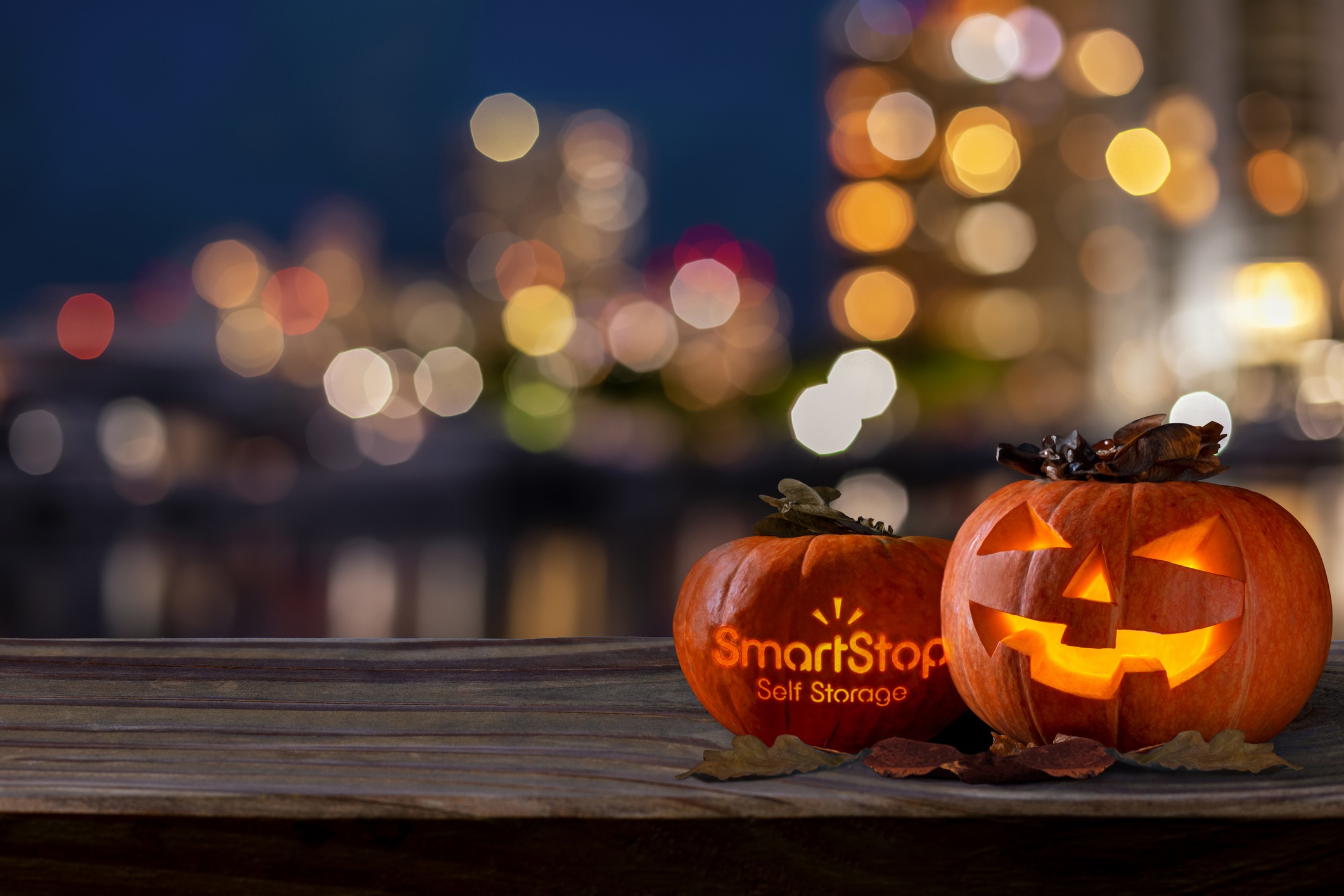 Image of 2 jack-o-laterns sitting on a wall in celebration of Halloween | SmartStop Self Storage 