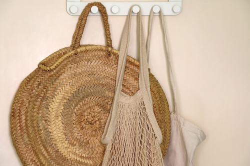 wicker and woven bags and wall hangings in a boho room