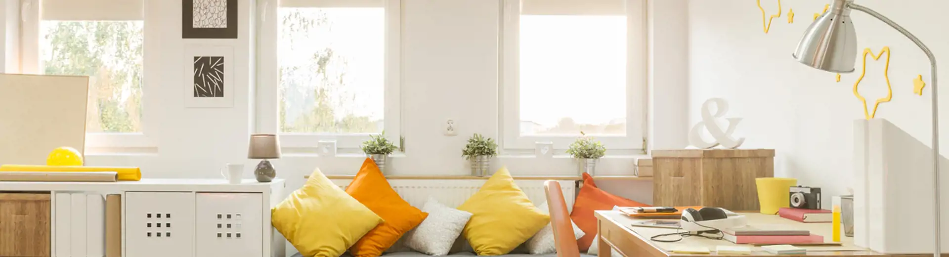 multifunctional living room space with office, daybed, and storage