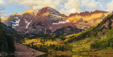 Image of lake surrounded by mountains covered in snow