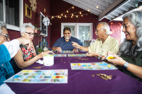 Group of elderly people playing games at the table