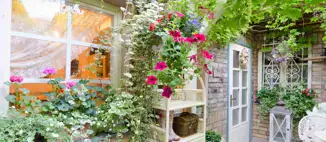 backyard storage cabinets surrounded by flowers and vines