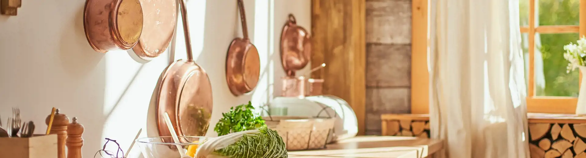 hanging copper pans on kitchen wall