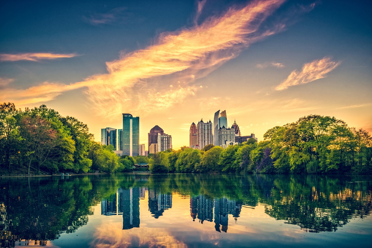 Image of Atlanta, GA skyline reflecting in lake from distance 