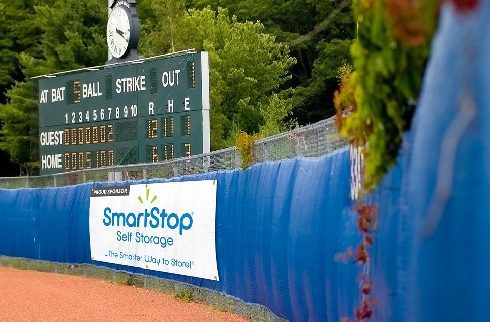 Image of baseball field scoreboard and banner highlighting SmartStop Self Storage's sponsorship of local sports. 