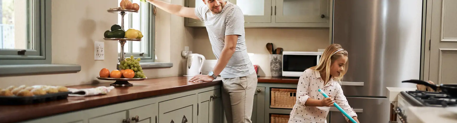 dad and daughter cleaning kitchen
