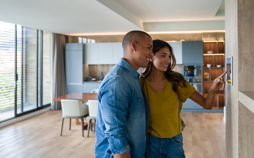 couple using home assistant device in living room