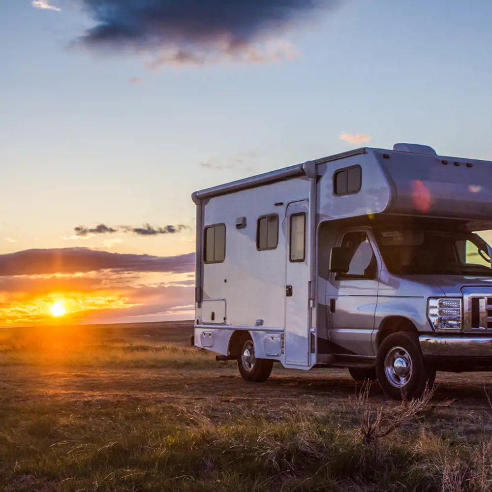 RV parked in the middle of a grassy area