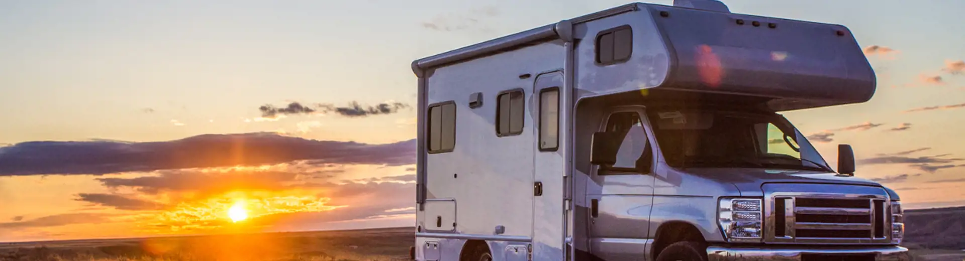 RV parked in the middle of a grassy area