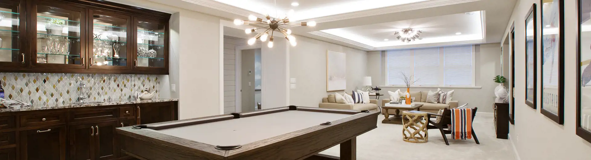 basement game room outfitted with pool table and couch
