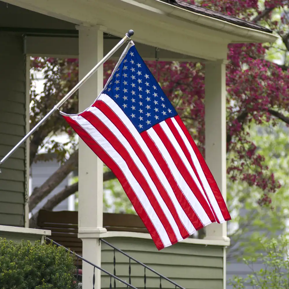 american flag being displayed outside of a home