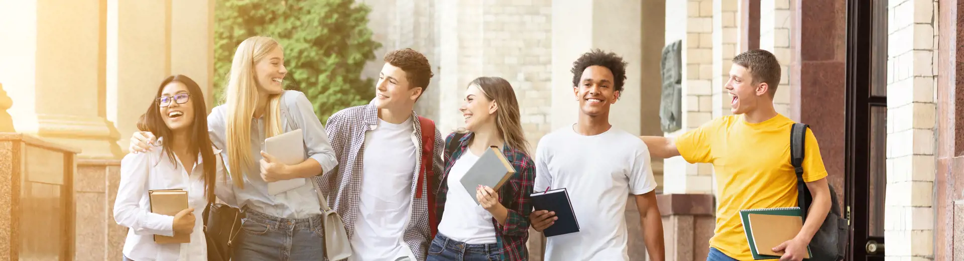 Someone’s hand, holding a pencil, resting upon a notebook and receipt, with a calculator to the right.