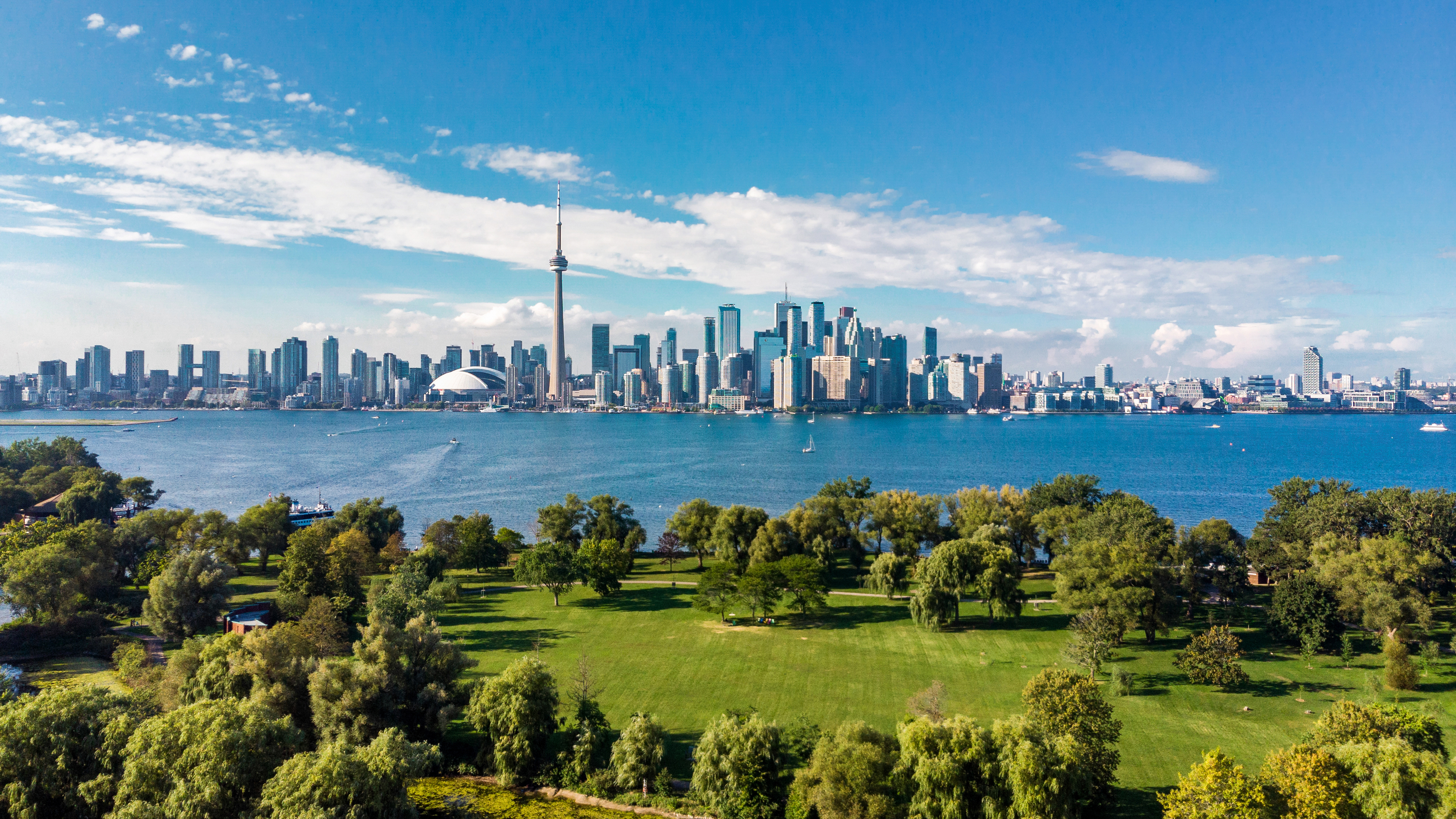 aerial shot of toronto city in canada with lush green area and skyscrapers