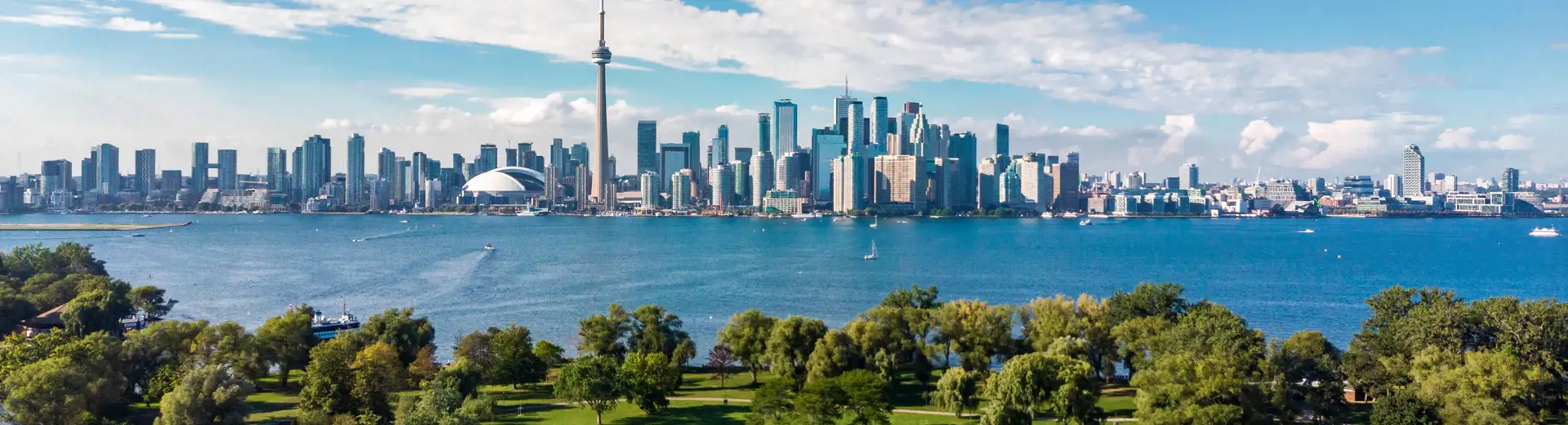 aerial shot of toronto city in canada with lush green area and skyscrapers