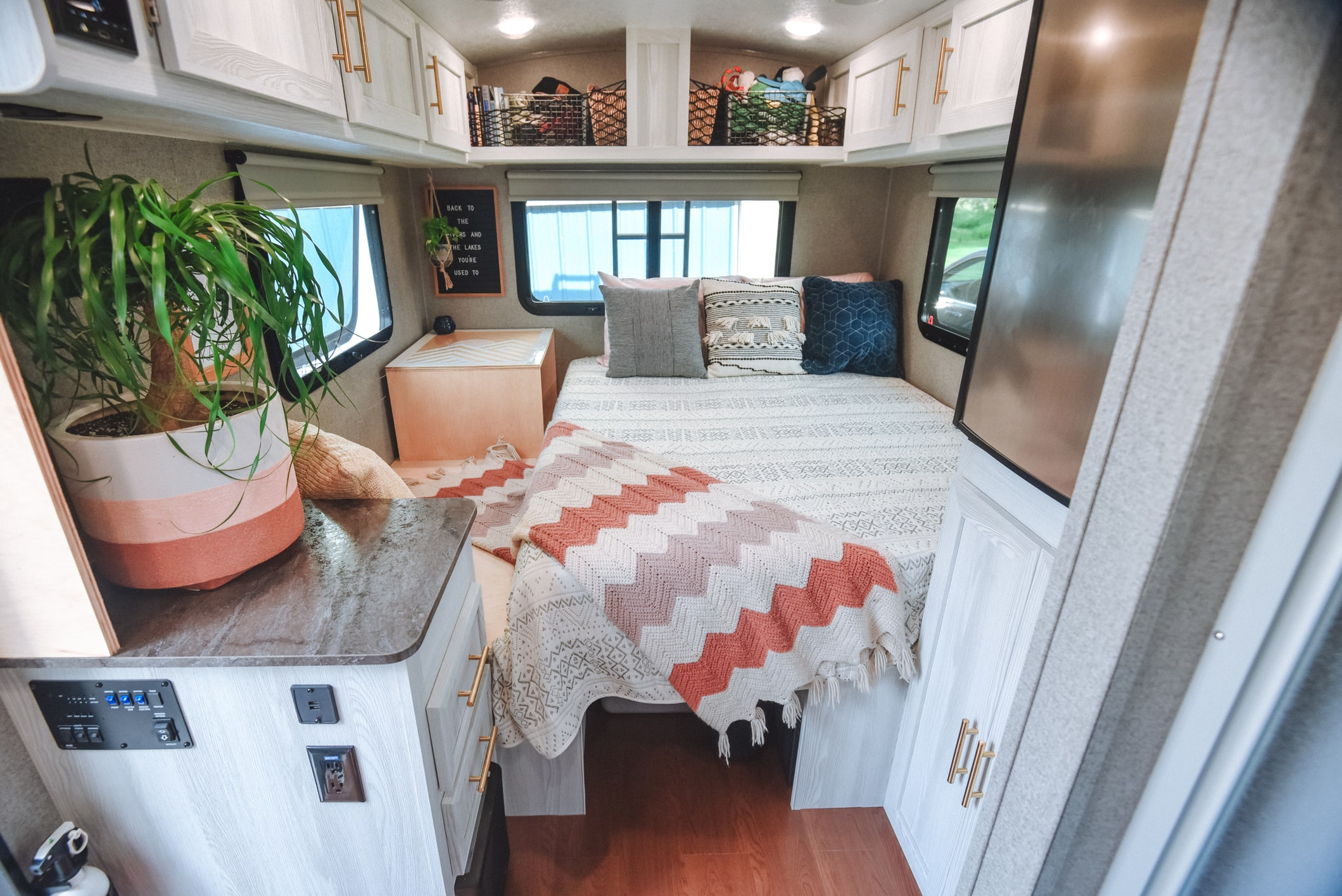 interior of modern camper with plant, organizers and charming decor