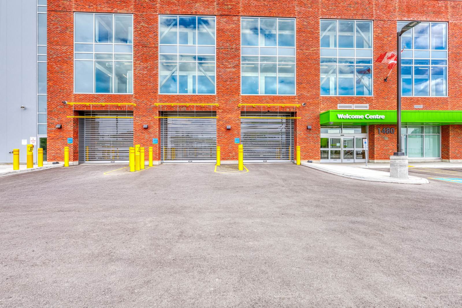 The front exterior of modern brick drive up entry at SmartStop self storage facility in Toronto, Ontario on 1480 Jane St.
