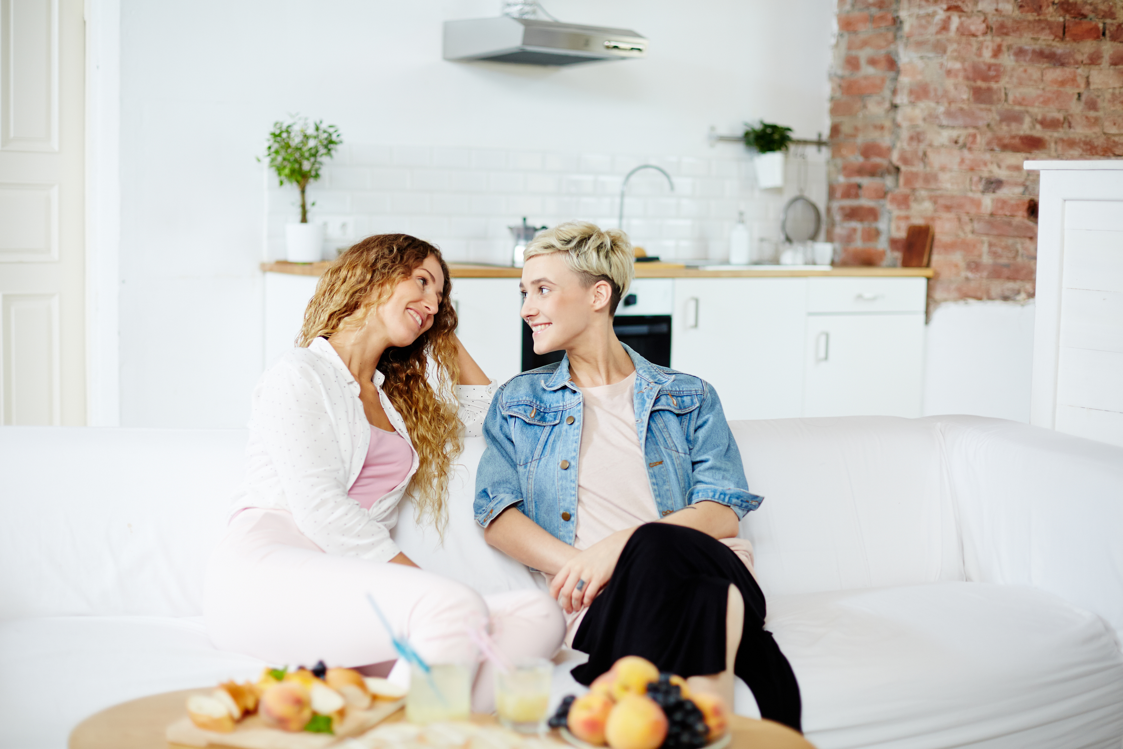 couple sitting on couch downsizing home
