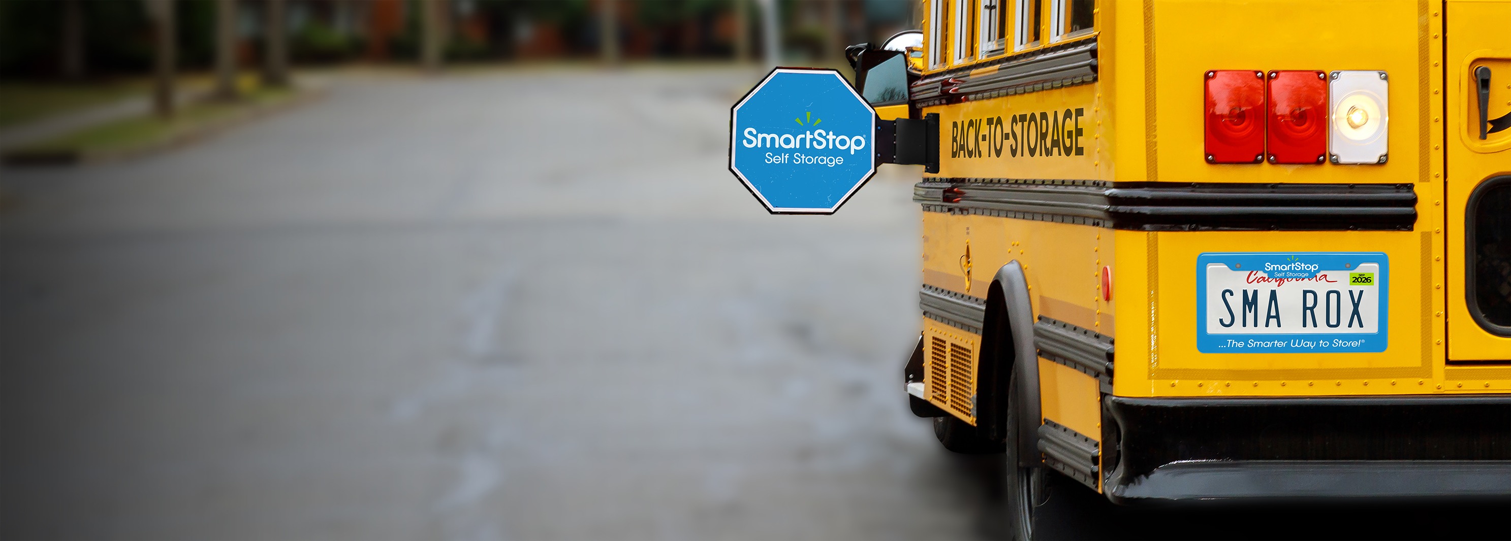 Image of SmartStop Branded School bus stopped in a neighborhood | SmartStop