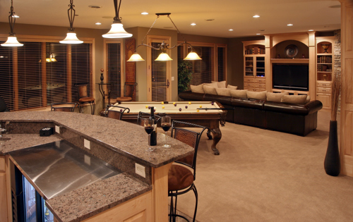 basement converted into home bar with pool table, couch, television, and other amenities