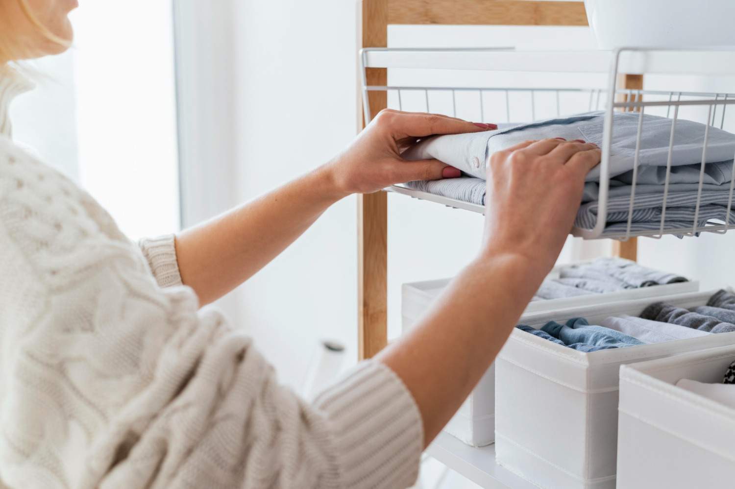 piles of folded clothes organized into keep, donate and discard categories