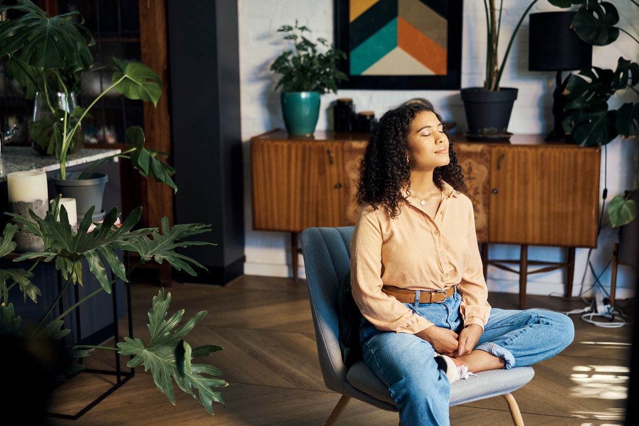 woman meditating while sitting on chair