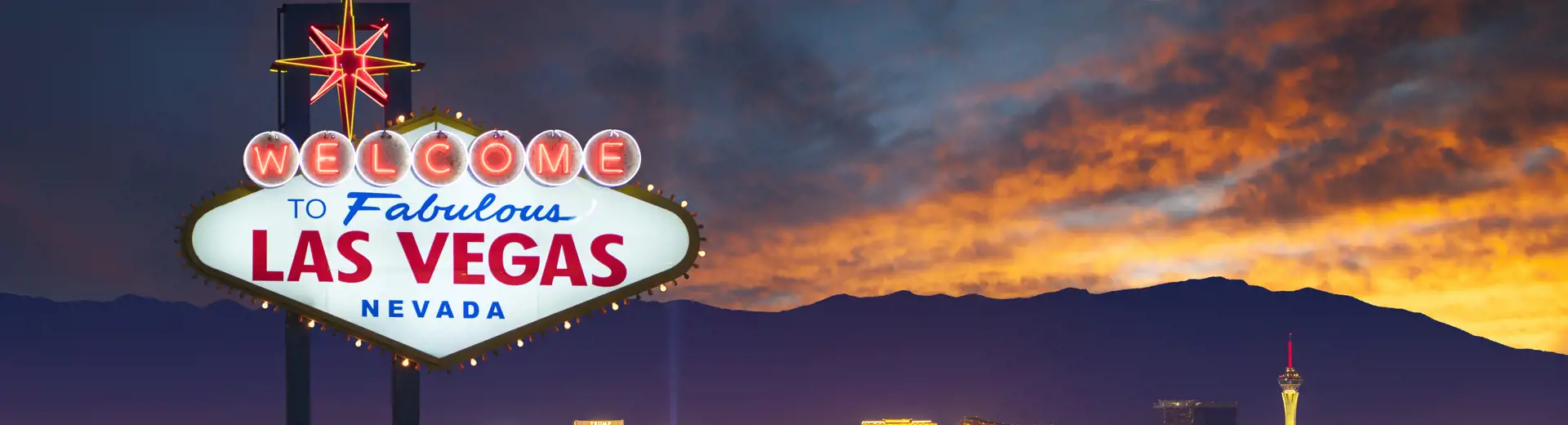 las vegas welcome sign and city at sunset