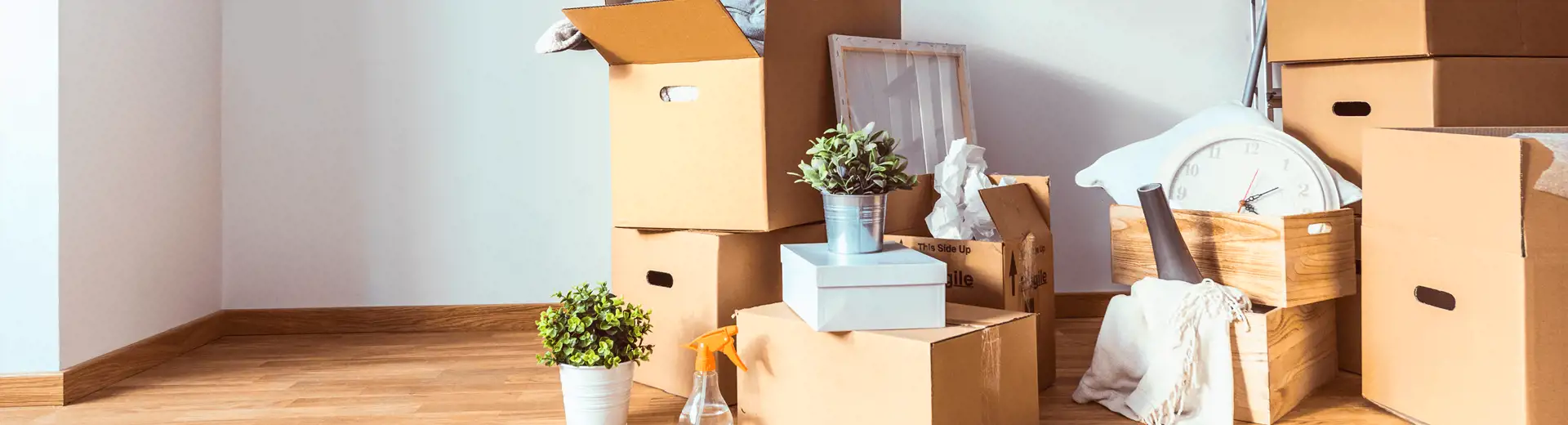 Image of stacked boxes open on the floor and surrounded by various items