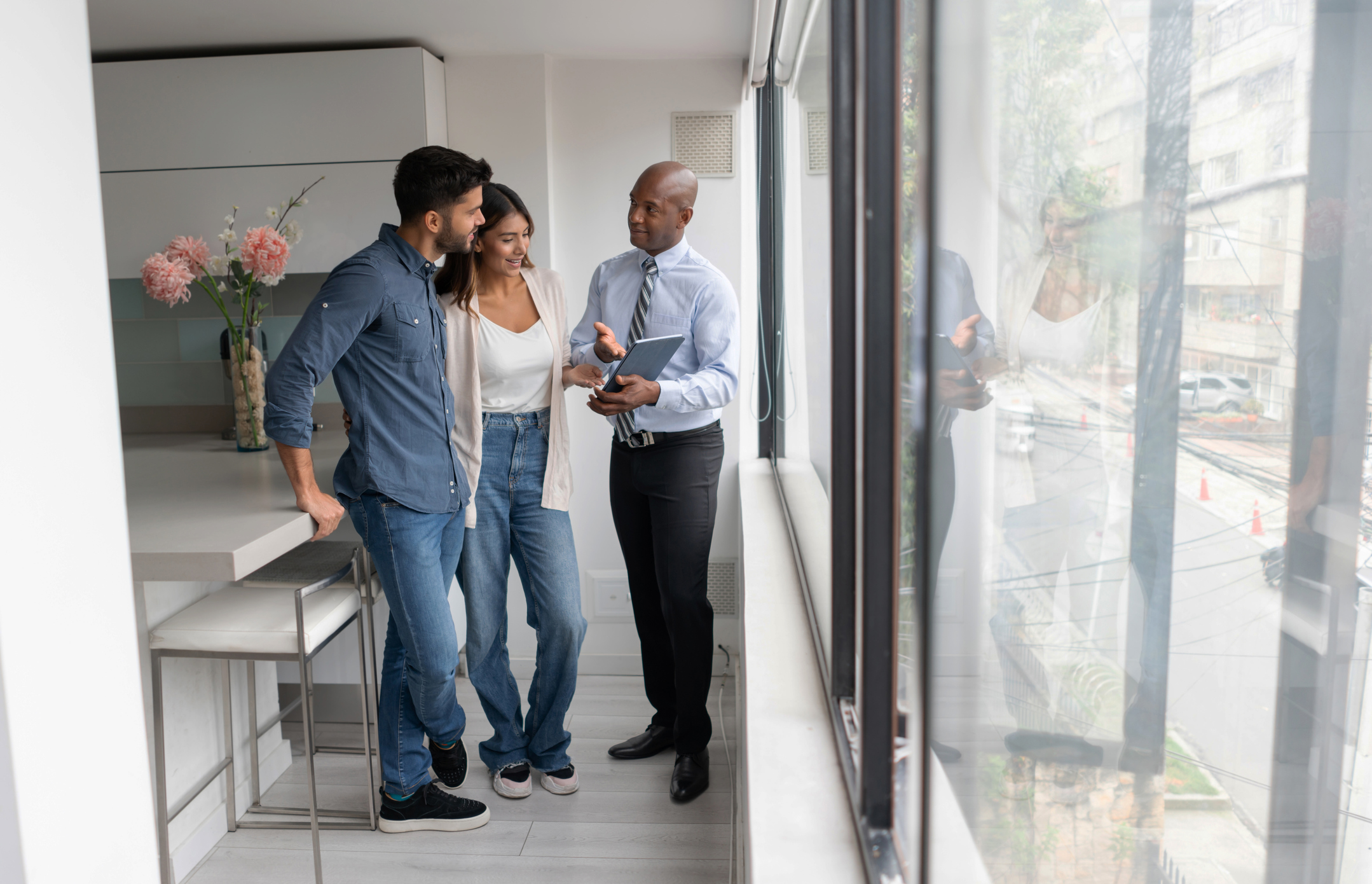 couple asking questions to broker during apartment tour