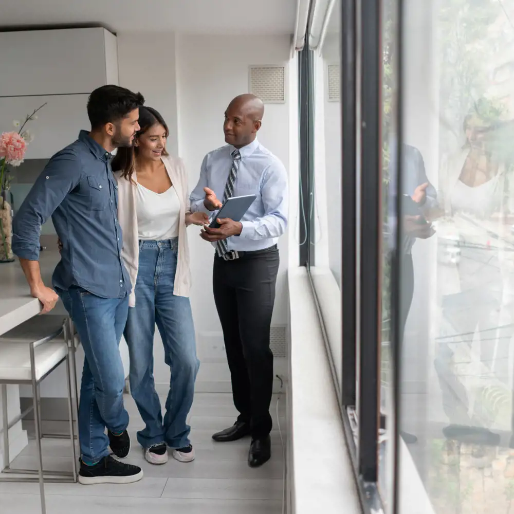 couple asking questions to broker during apartment tour
