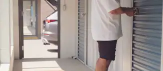 man unlocking disc lock on storage unit