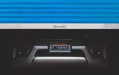 Image of vehicle in storage unit with door partially open | SmartStop