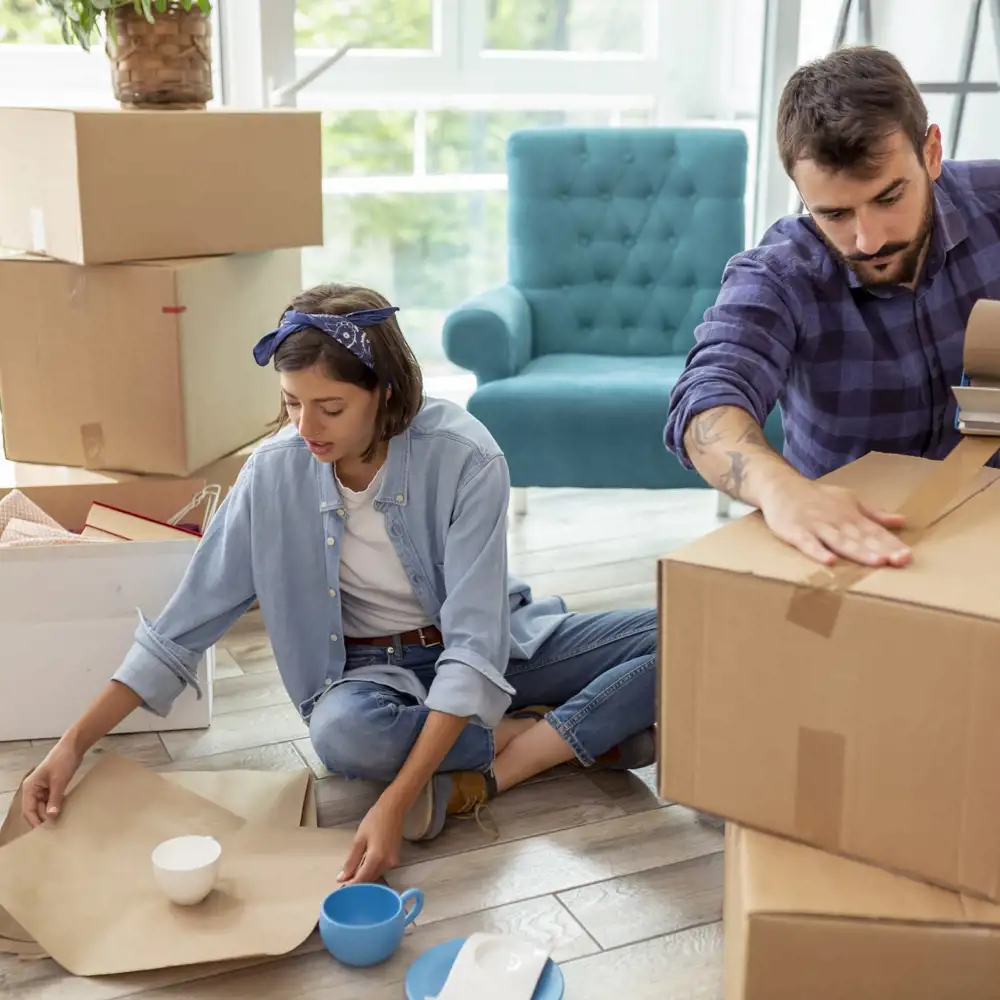 couple packing up boxes while moving