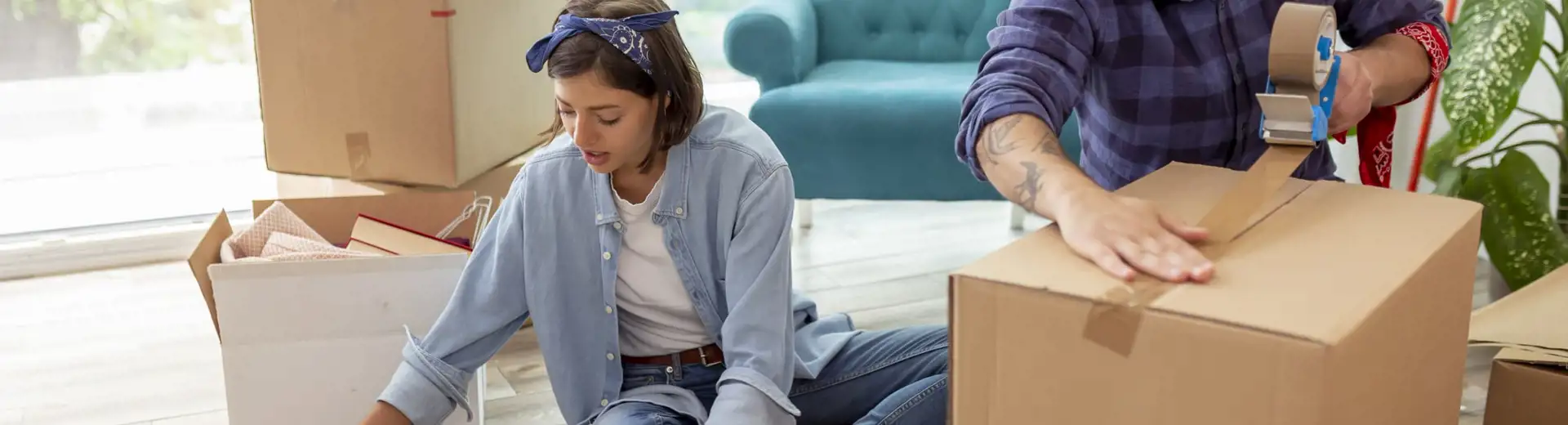 couple packing up boxes while moving