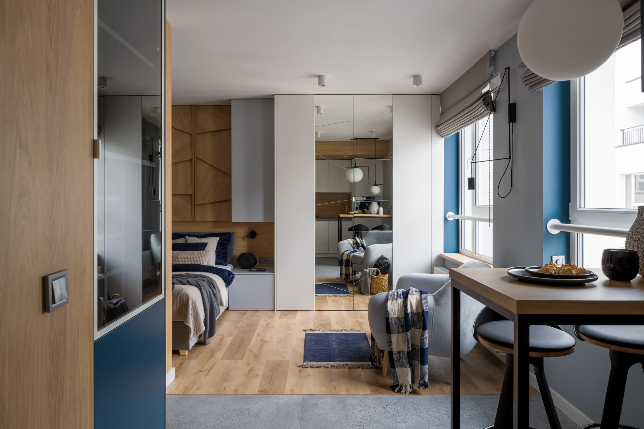 modern and stylish single studio apartment with bedroom open to kitchen area with table