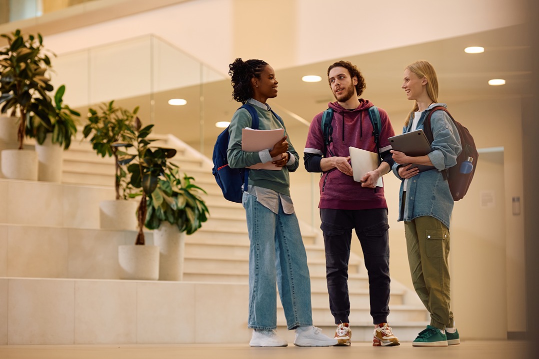 College students standing in hall having converstion