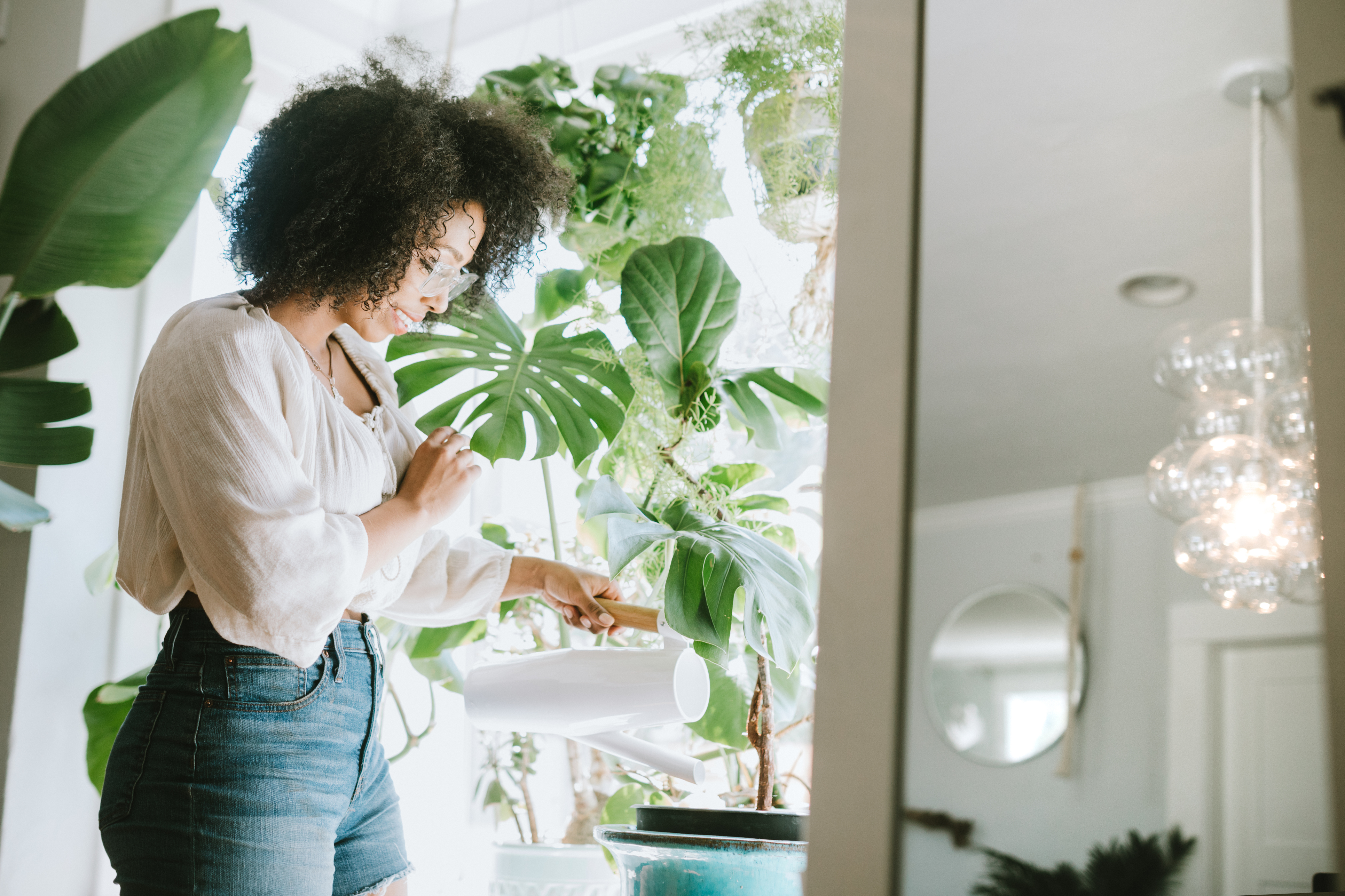 woman watering plants at home