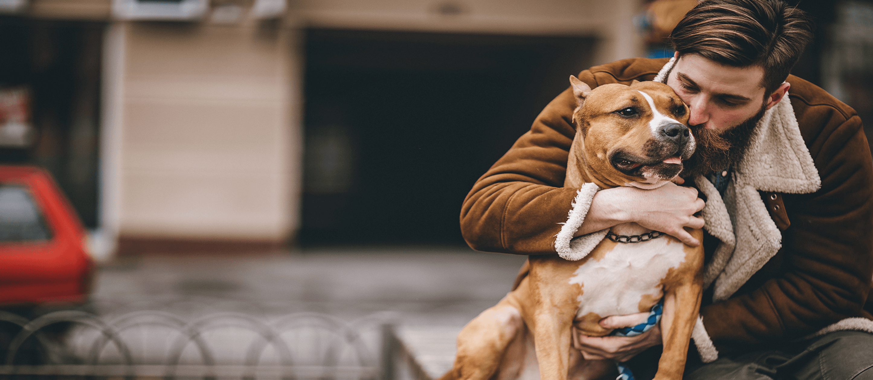 Image of man hugging his dog
