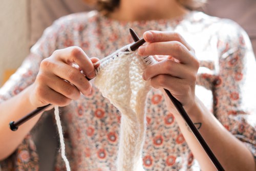 Woman knitting a blanket