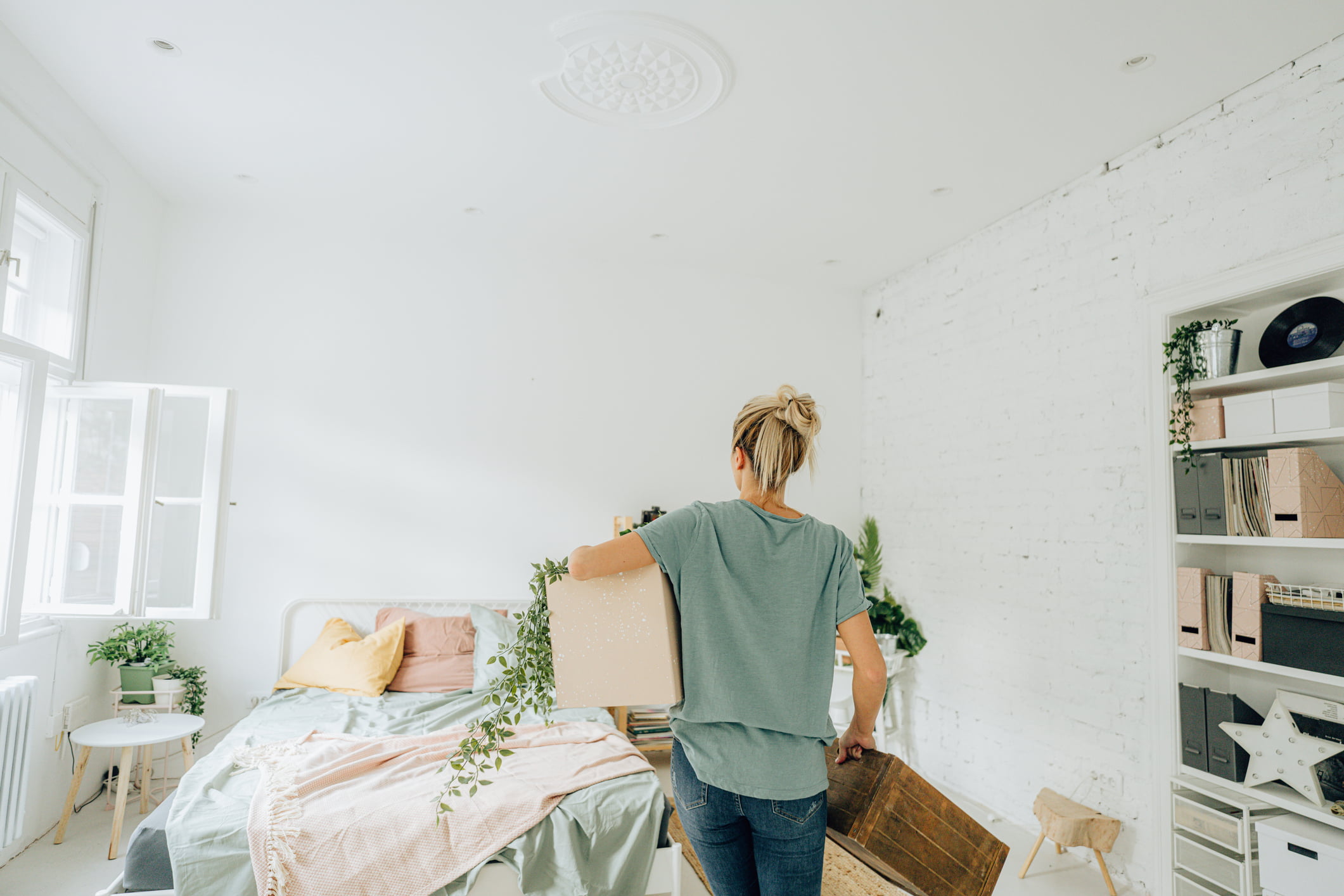 woman reorganizing bedroom