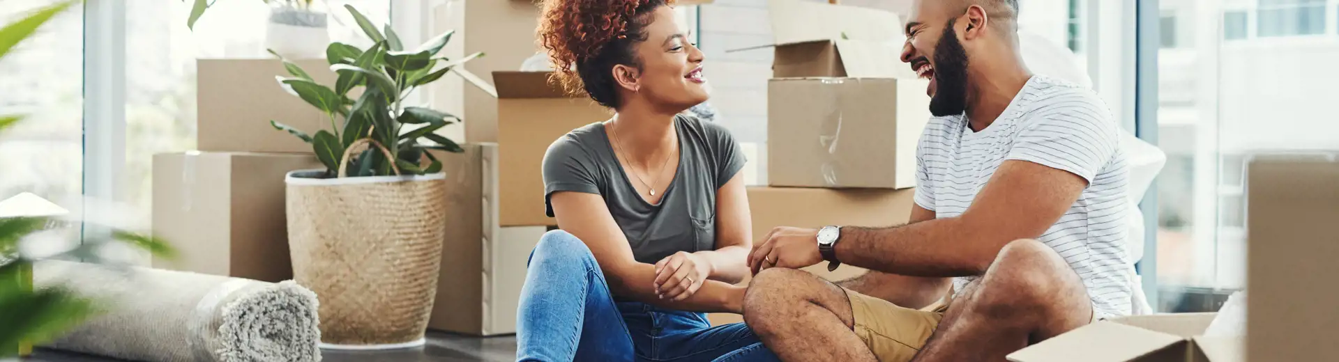 couple sitting down for a break while in the process of packing and moving