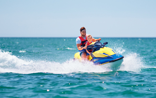 Dad and son riding on jetski