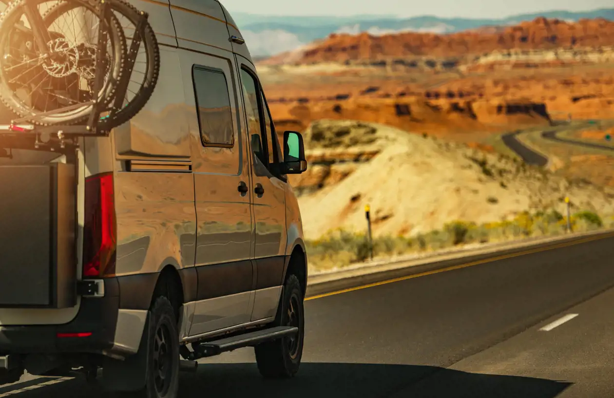 Image of RV driving along high desert mountain highway