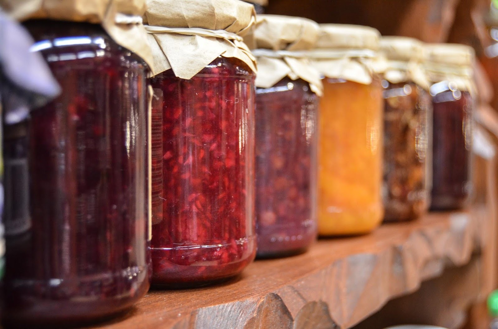 Mason jars filled with assorted foods items, sitting on a shelf